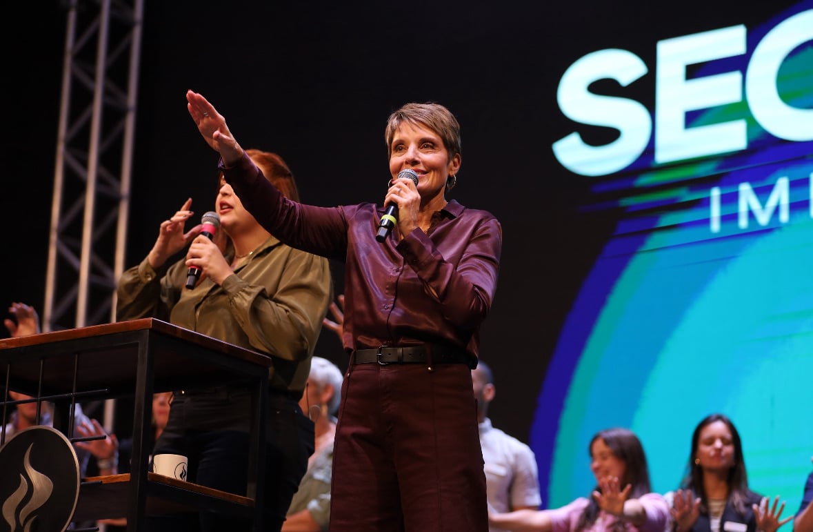 Joanne Moody teaching from the stage at a live event