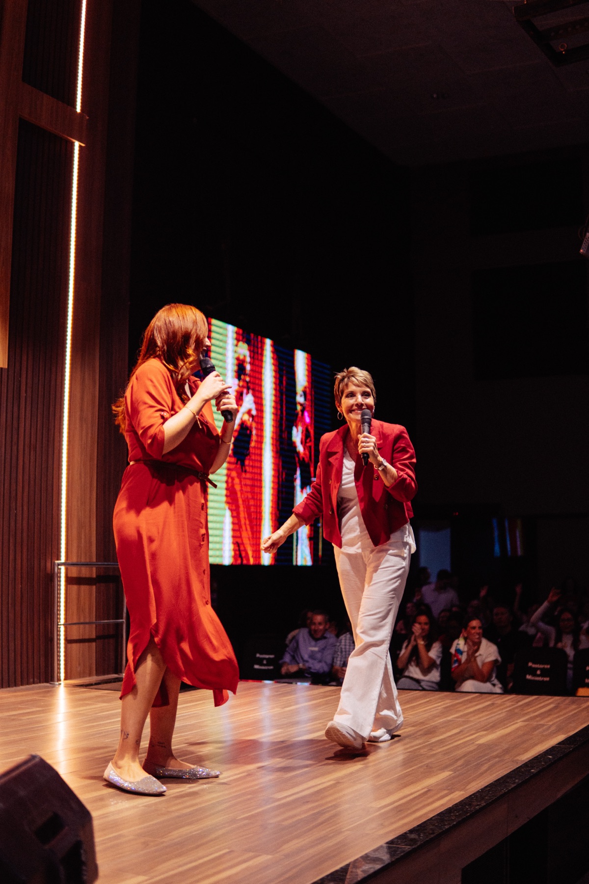 Joanne Moody teaching from the stage at a live event